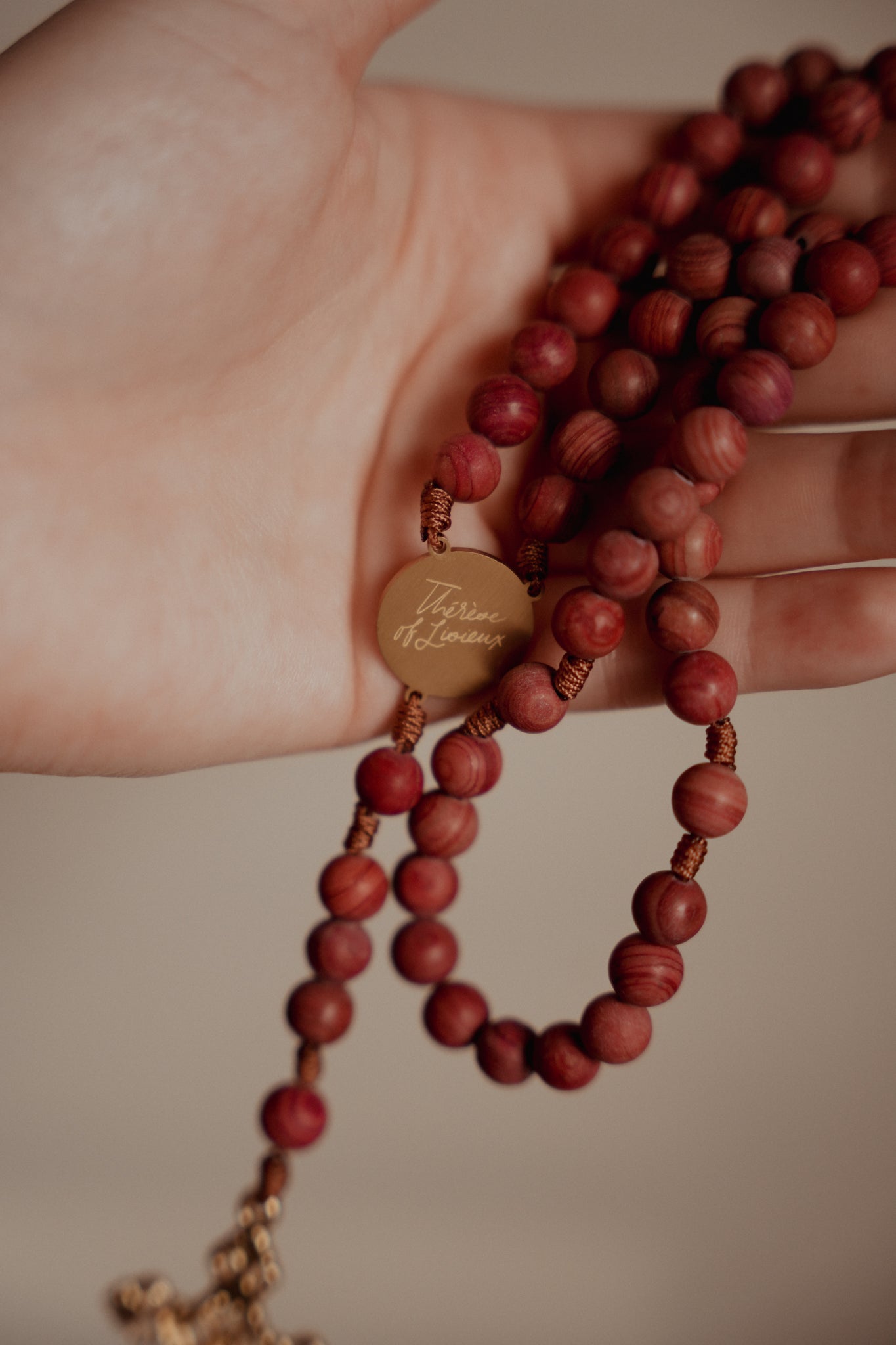 Hand holding St Therese Rosary