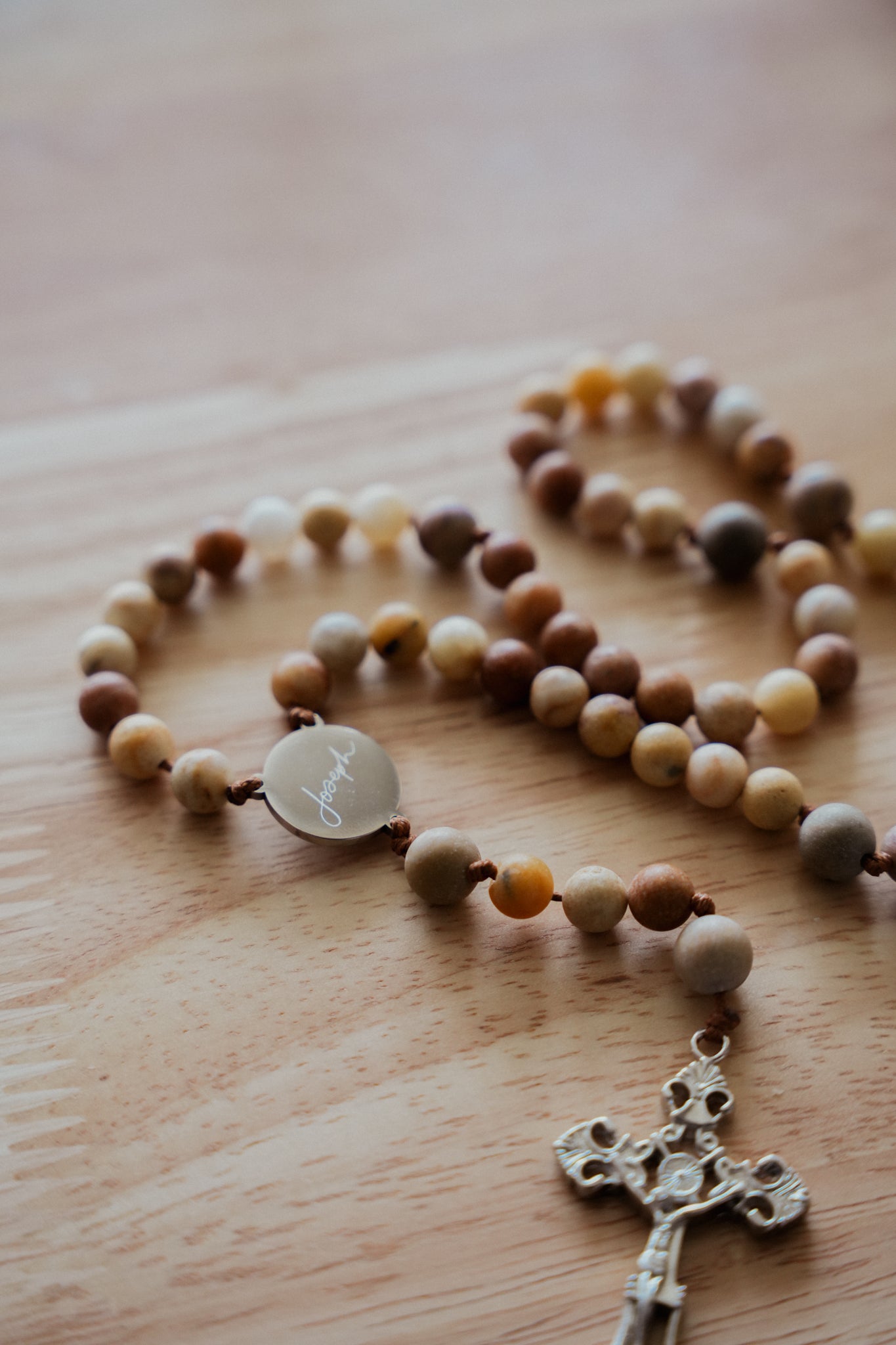 Close-up of a rosary featuring a St. Joseph medal centerpiece