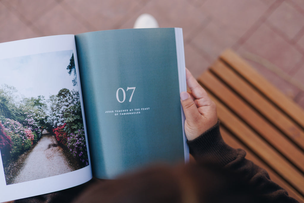 Hand holding the 8x10 inch hardcover Gospel study book