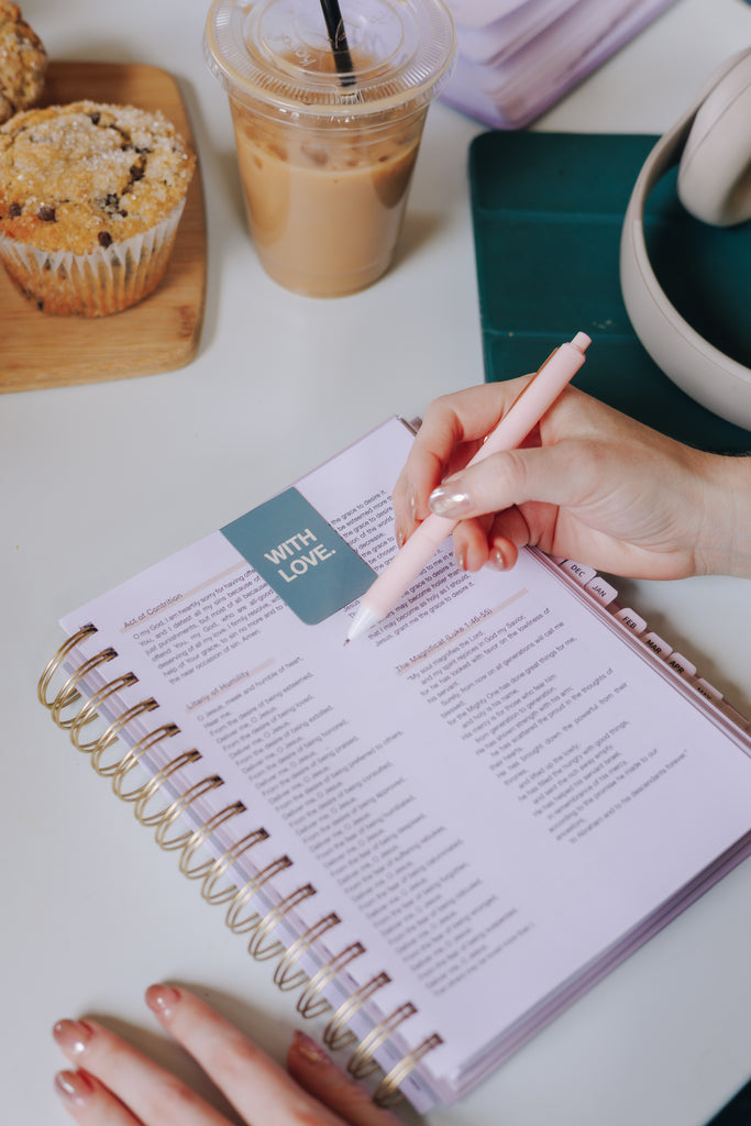 Bible study setup with pastel highlighters, pens, and notebook