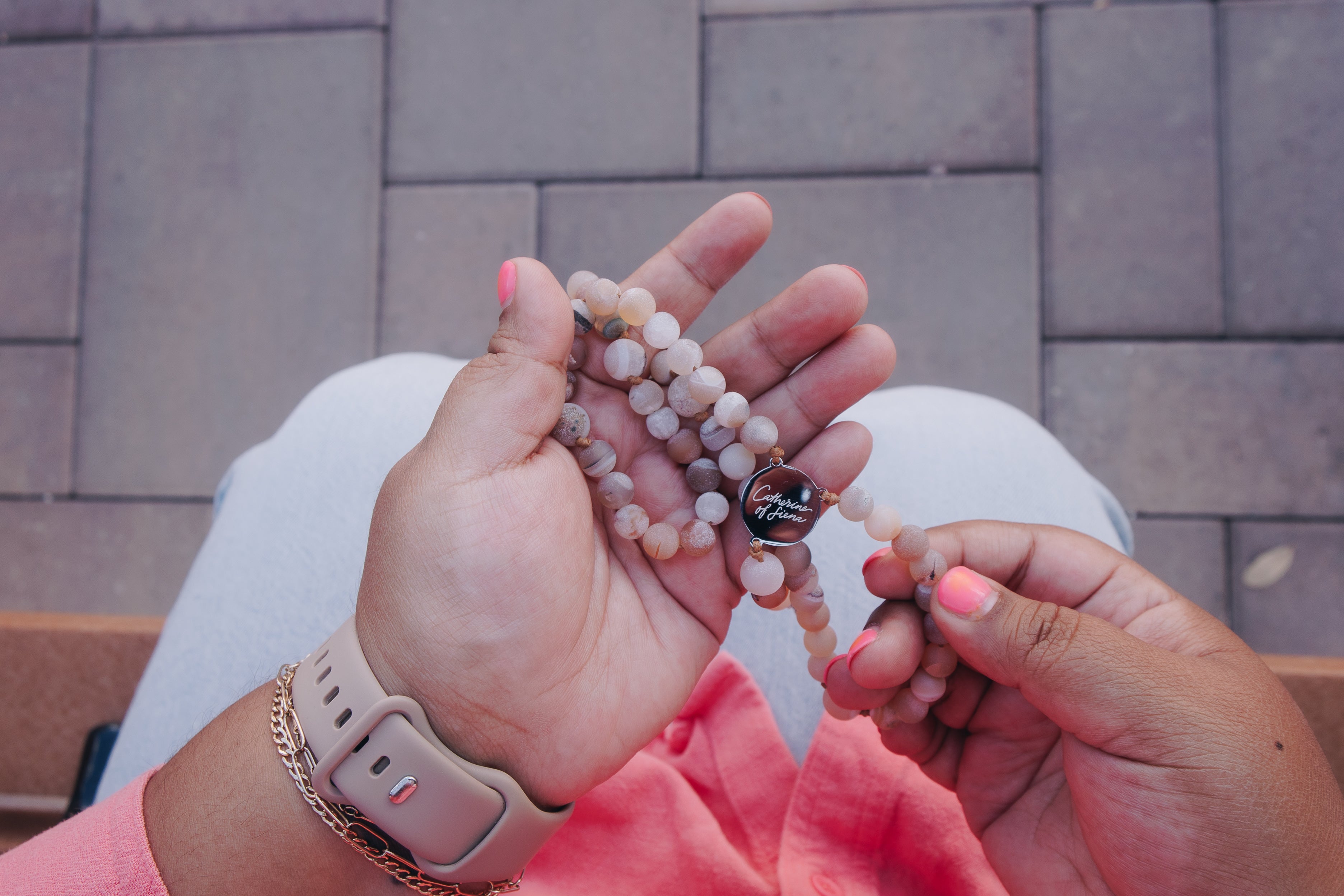 Hand praying with St Catherine of Siena Rosary