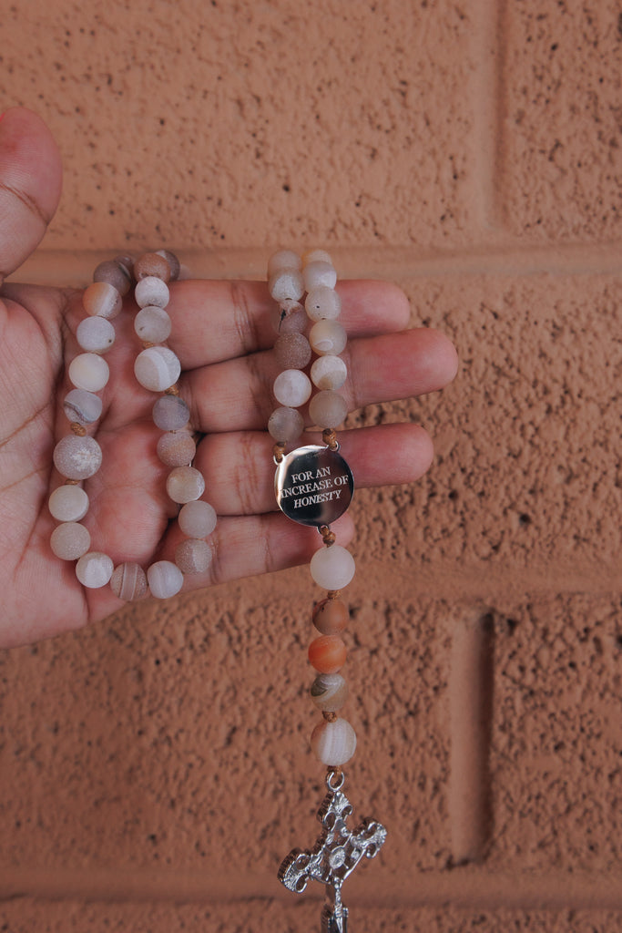 Hand praying with St Catherine of Siena Rosary