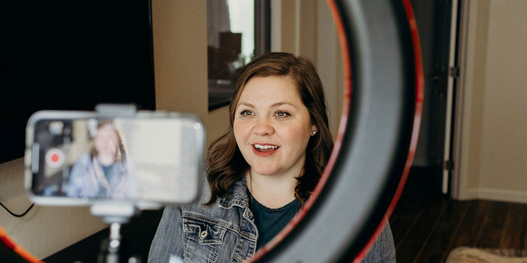 Woman filming Teachable Tuesday podcast with phone 