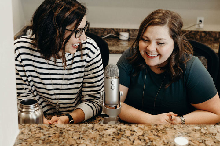Two women sitting together recording a Teachable Tuesday podcast